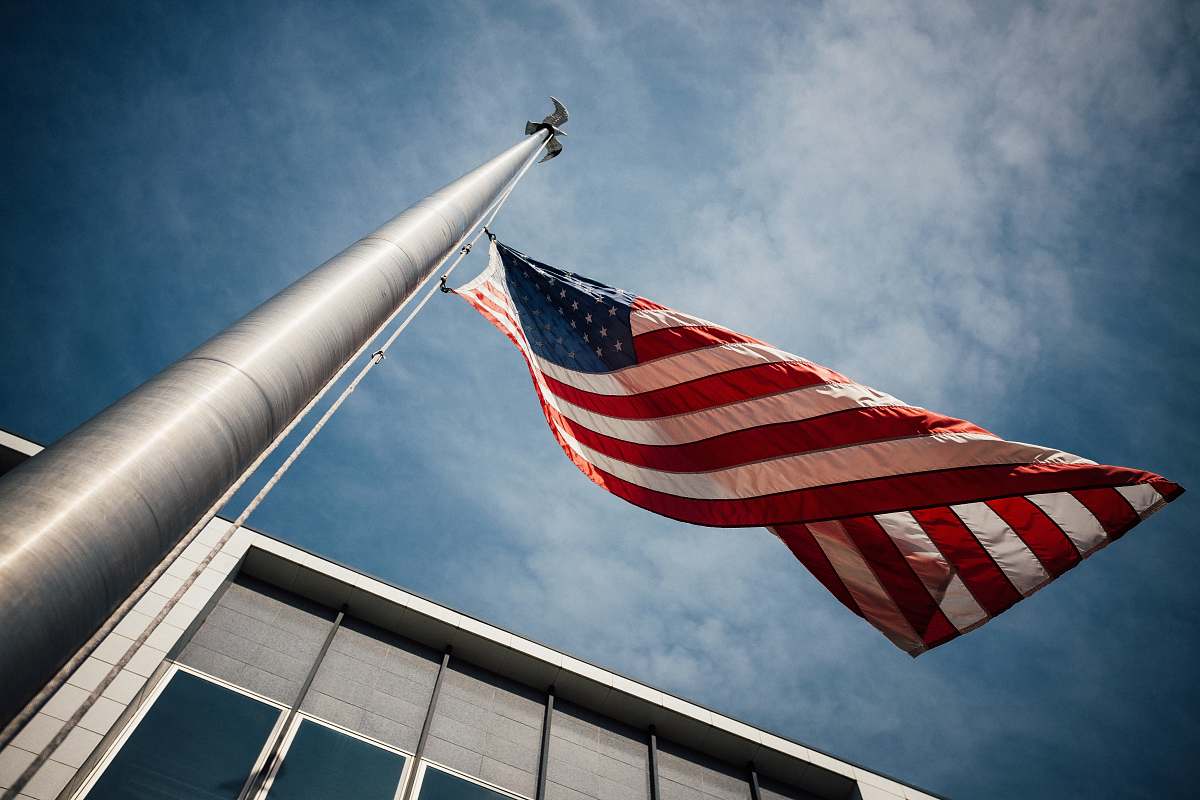 emblem low-angle photo of U.S. flag placed on gray pole flag