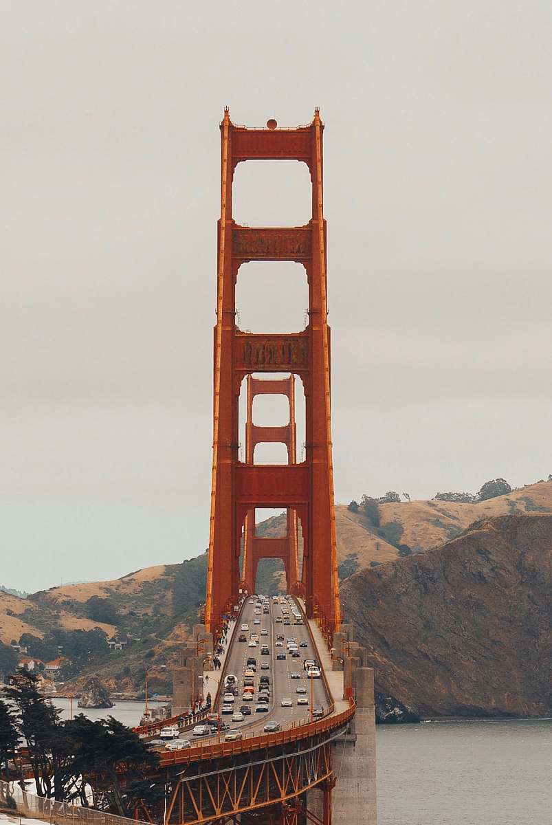 bridge orange bridge near mountain range architecture