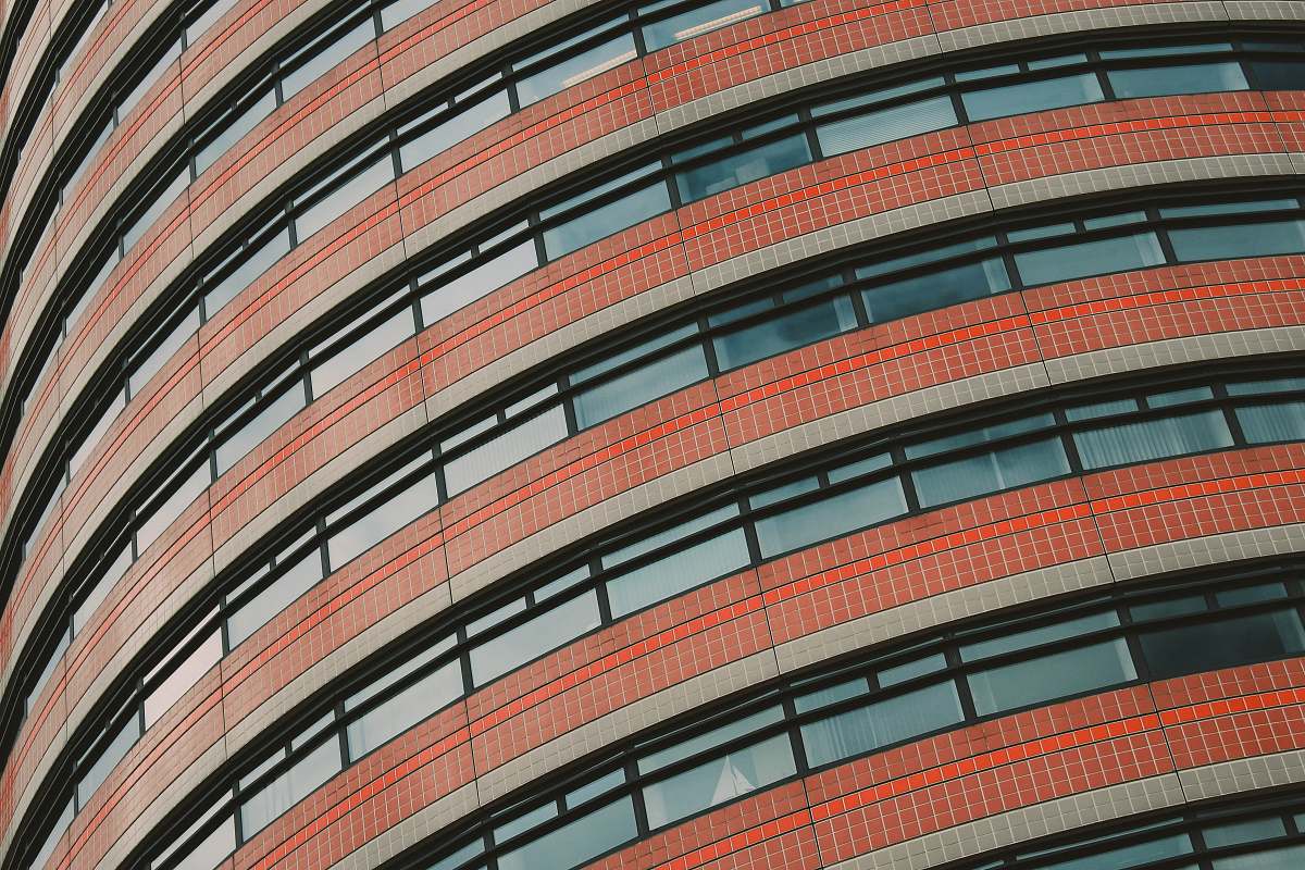city red and clear concrete glass building low angle photography urban