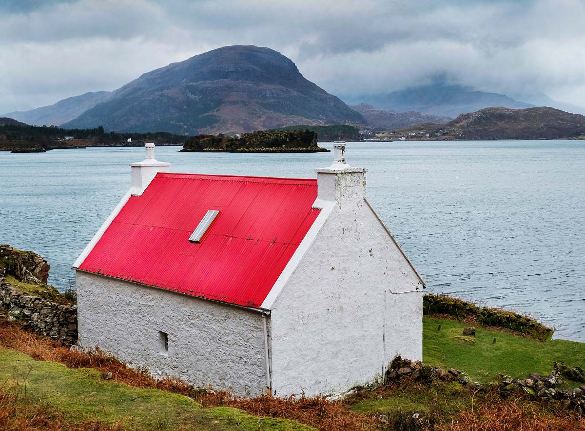 sea white and red concrete building near body of water during daytime coast