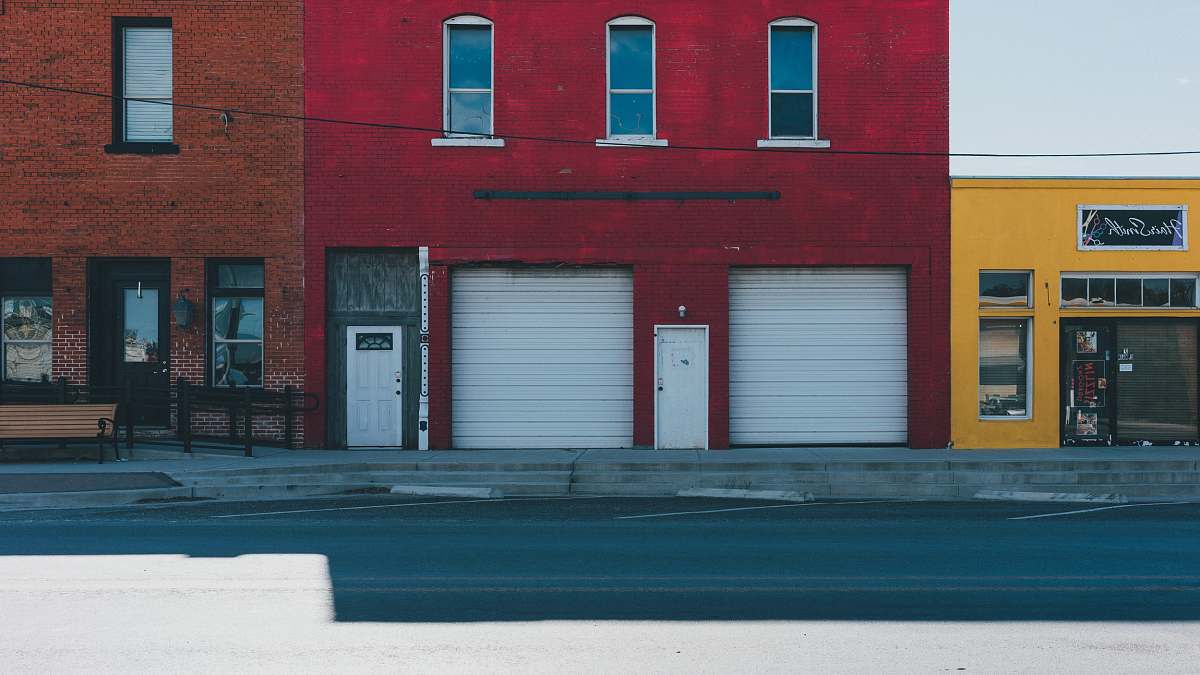 brick white garage doors closed during daytime city
