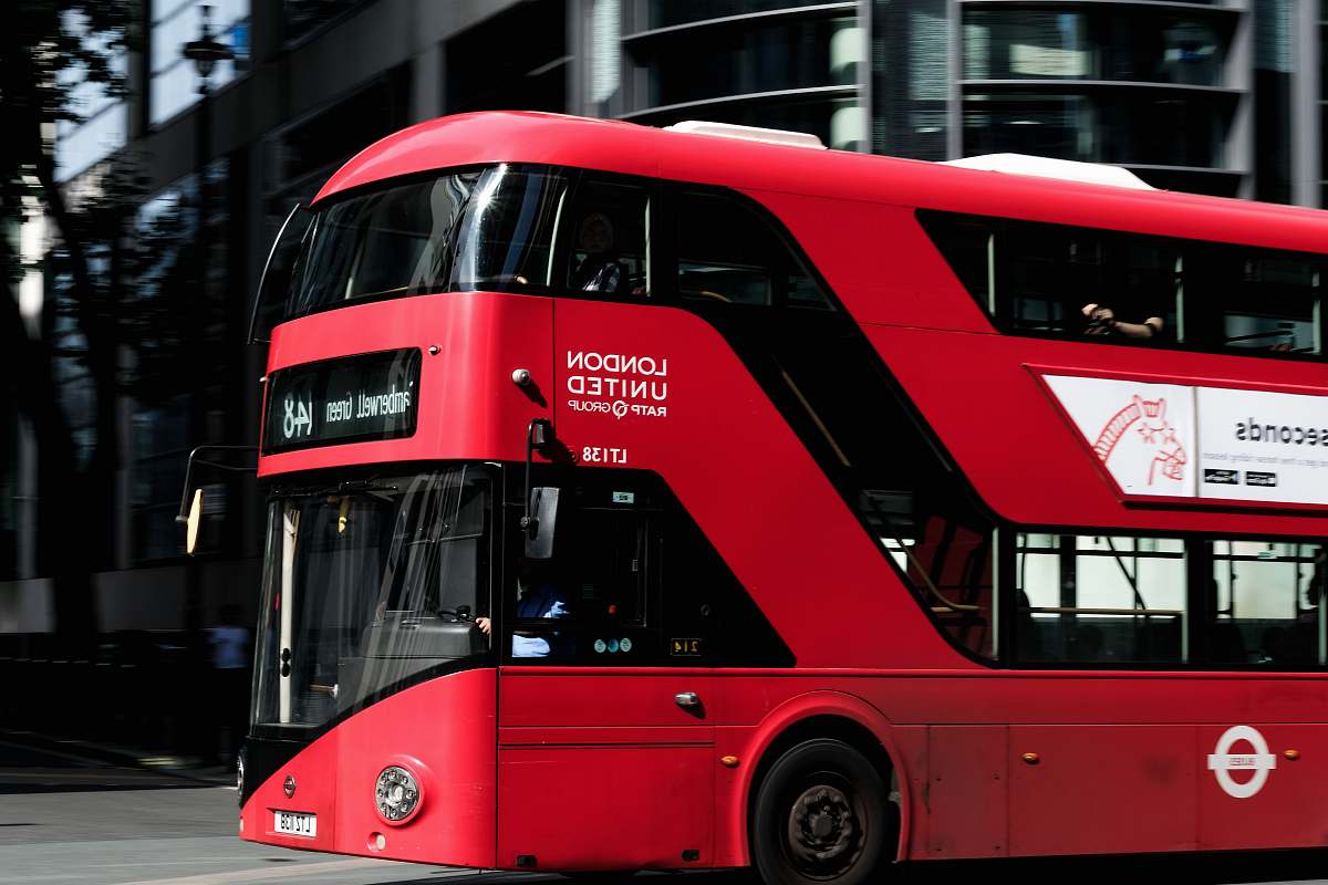 transportation red and black bus near building vehicle