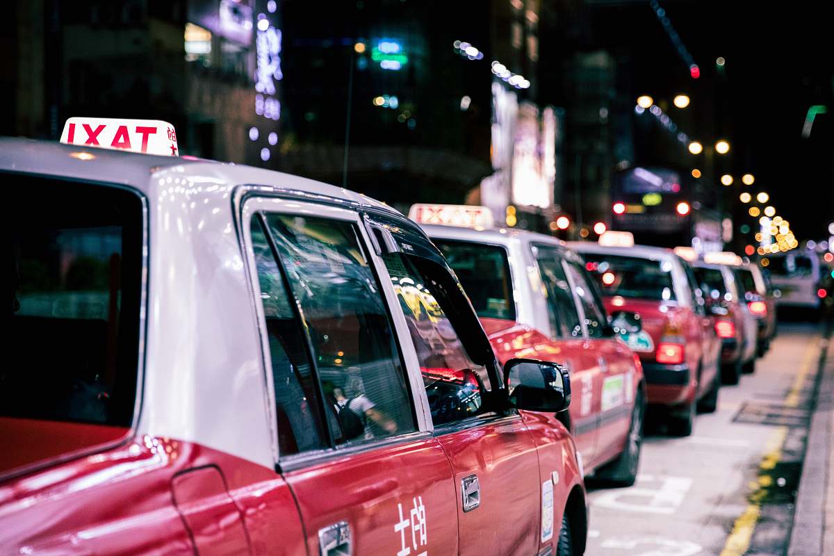 car red taxis on road during nighttime taxi