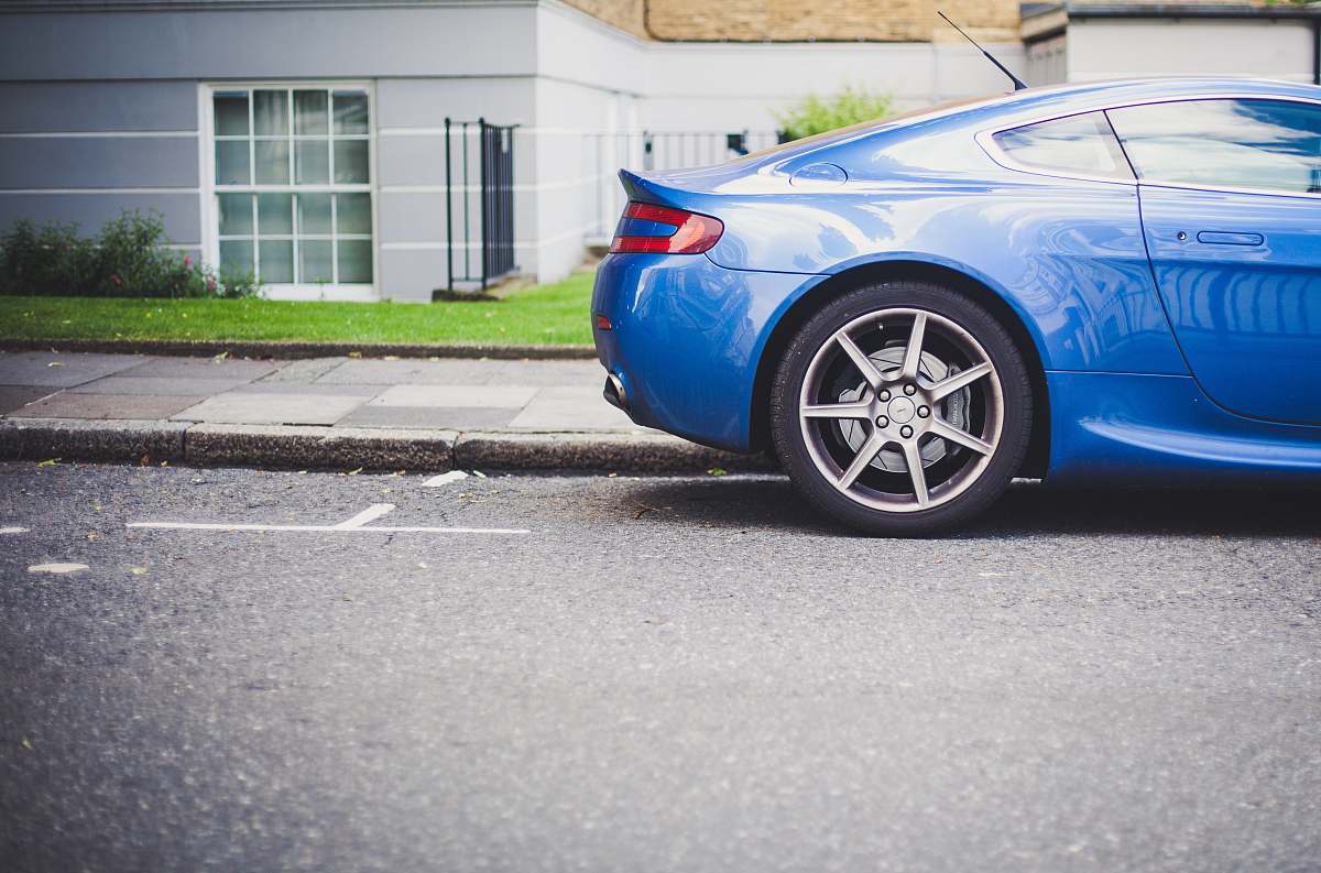 vehicle blue coupe parked in front of house sports car