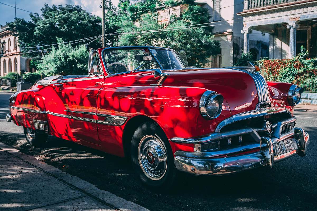 cuba classic red convertible coupe parked beside road havana