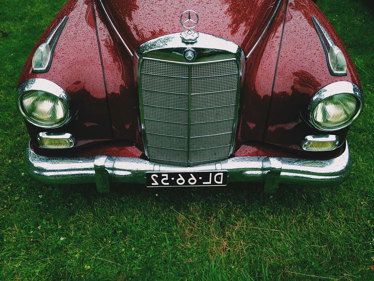 bumper classic red Mercedes-Benz car with DL6652 license plate oldtimer