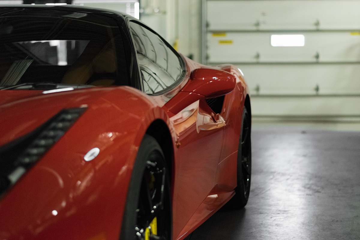 automobile close-up photography of red coupe vehicle
