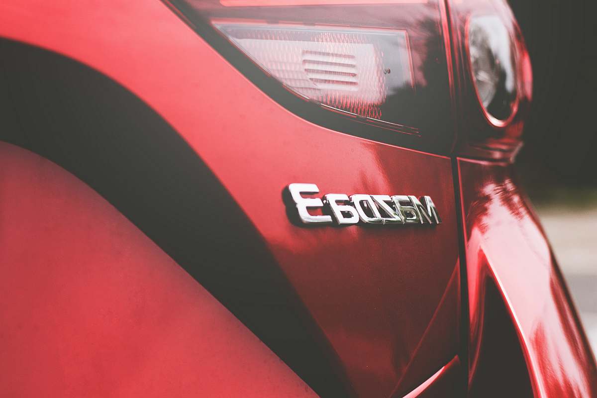 red closeup photography of red Mazda 3 vehicle mazda