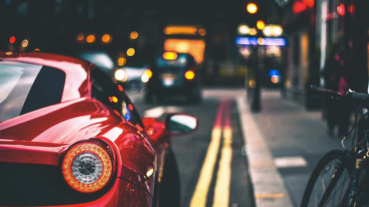 vehicle red car on street bike
