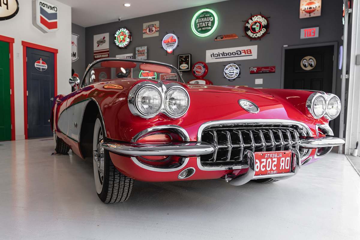 classic red coupe inside gray garage vintage