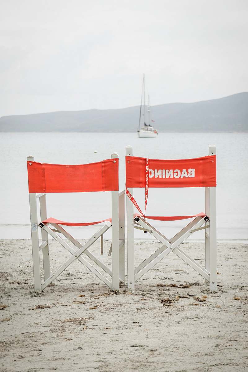 yacht two white folding chairs during daytime at beach boat