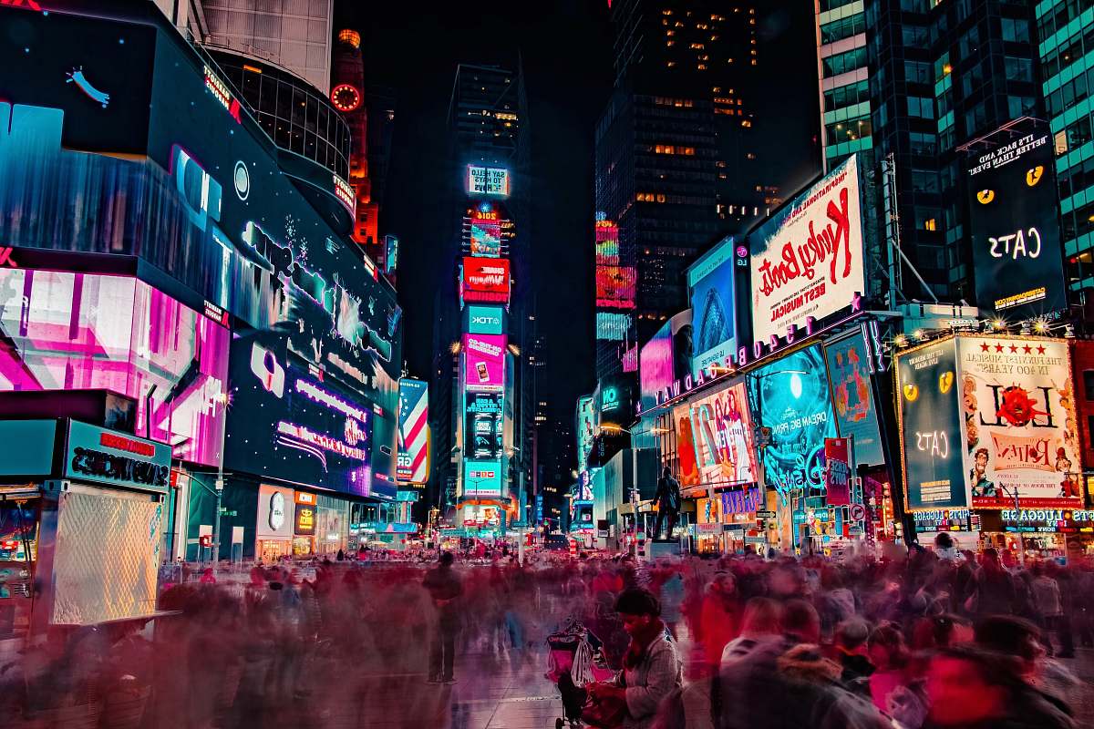 building time-lapse photography of crowd of people on New York Time square during night time night