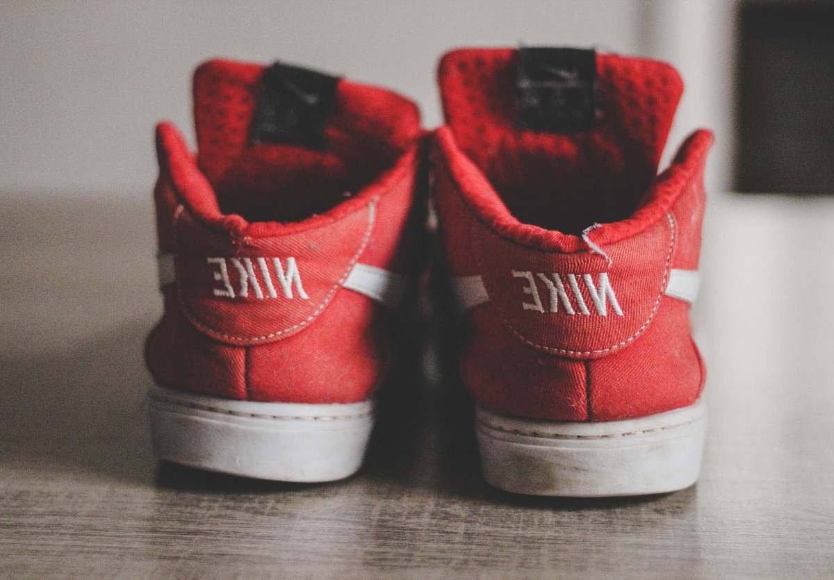 footwear closeup photography of pair of red-and-white Nike low-top shoes brasília