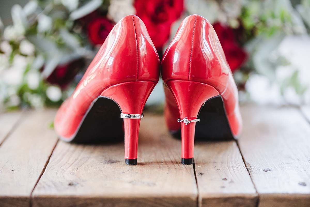 apparel pair of red patent leather heels on wooden surface footwear