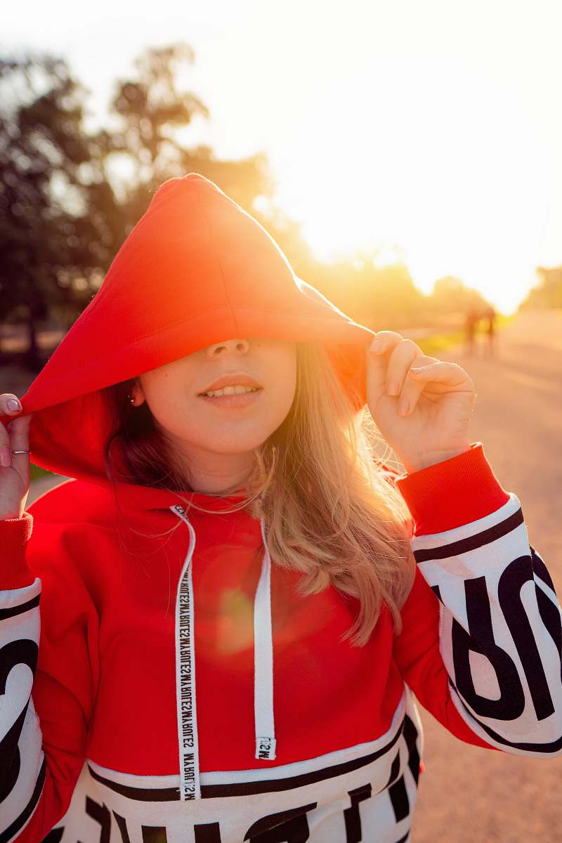 apparel woman wearing red and white pullover hoodie during sunrise hood
