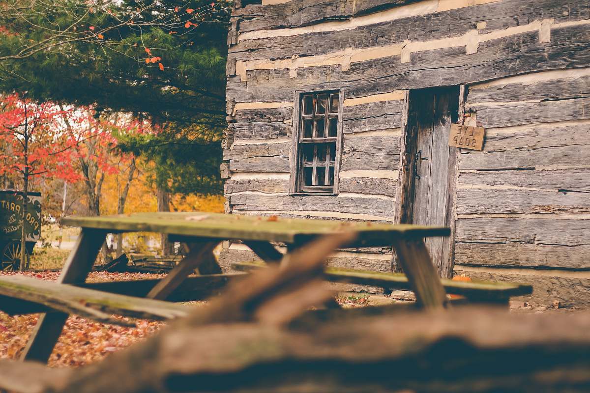 building picnic table near wooden house cabin