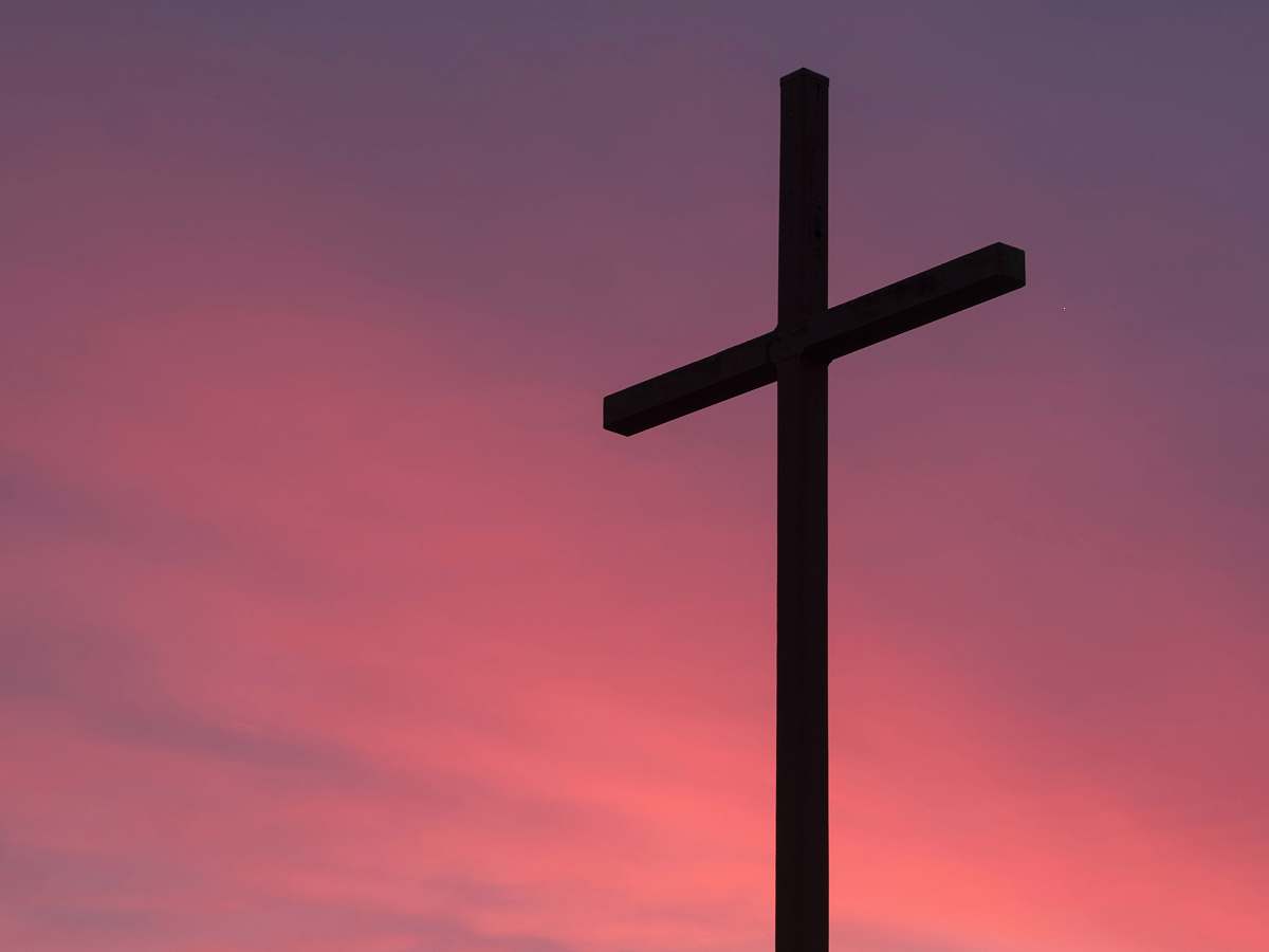 emblem brown wooden cross during golden hour pink
