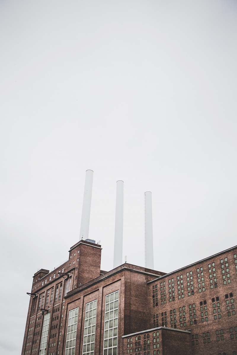 building brown factory under clear sky factory