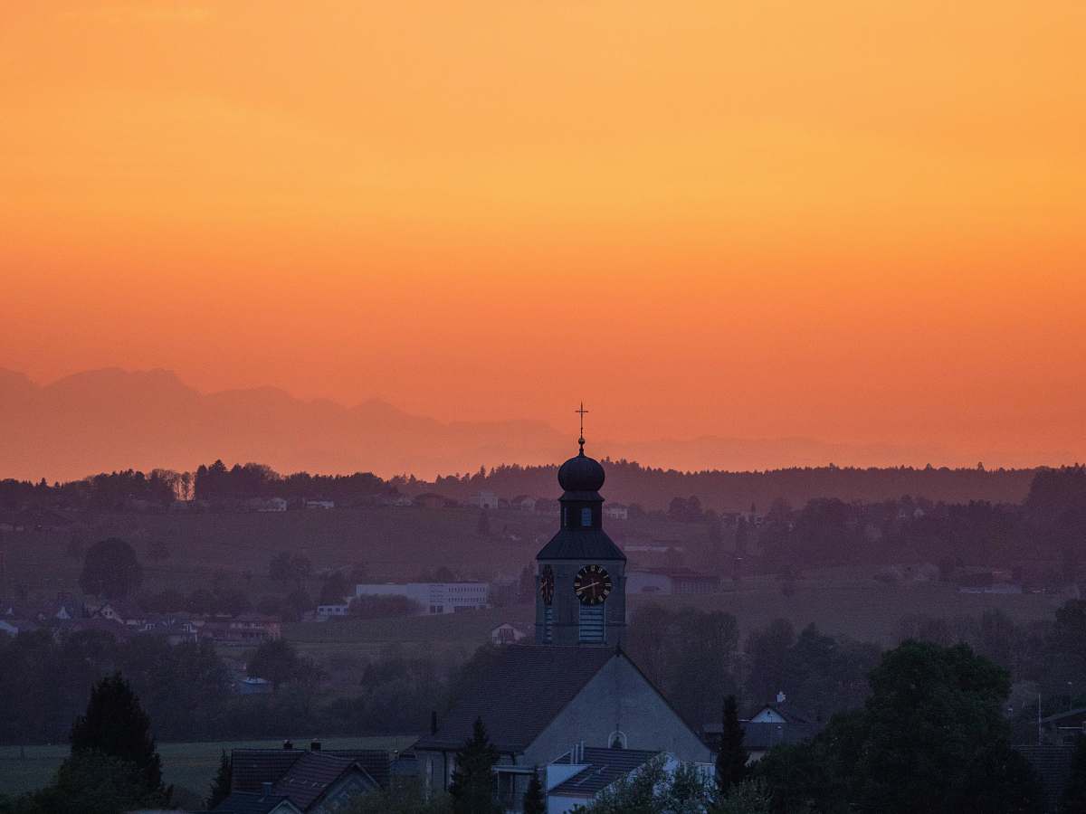 dawn silhouette of gray building during golden hour red sky