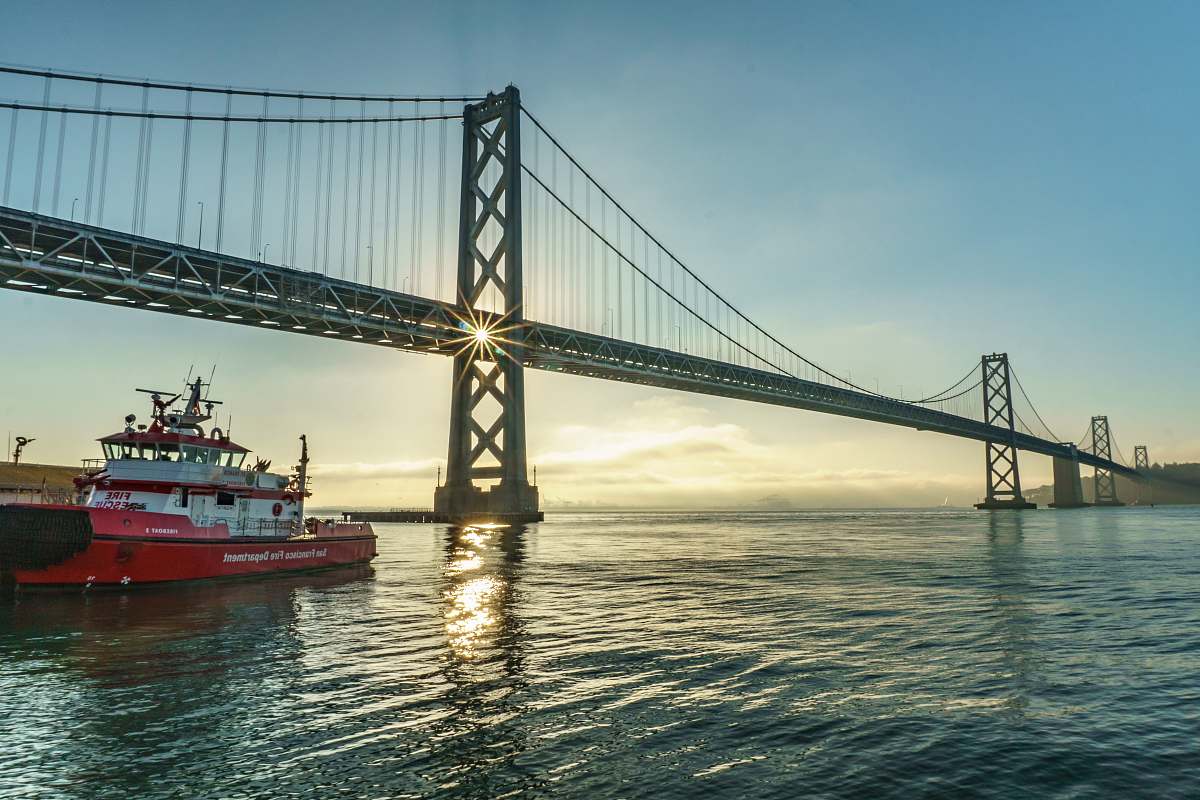 boat ship sailing under bridge san francisco