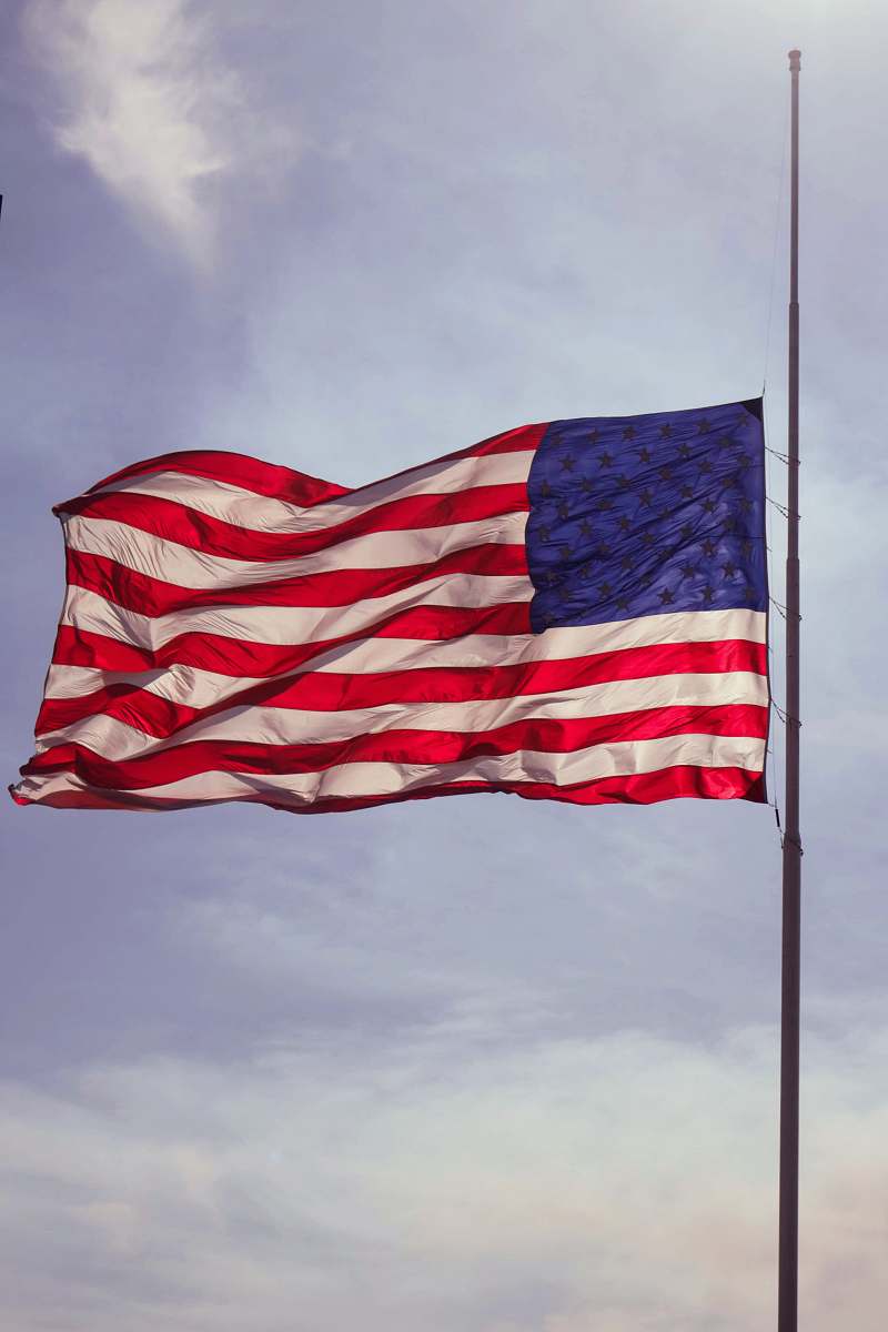 emblem U.S. flag under blue skies red