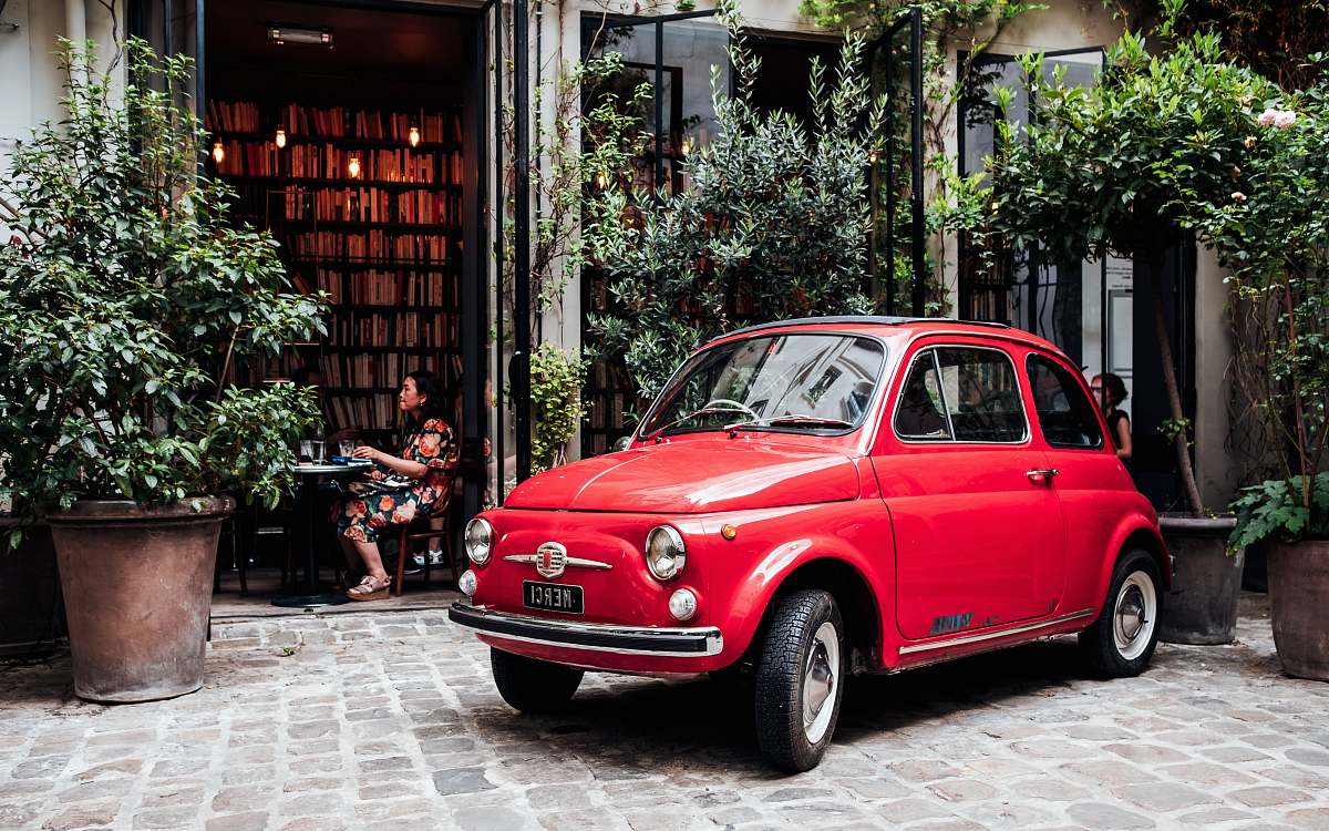 vase red 3-door hatchback parked outside establishment pottery