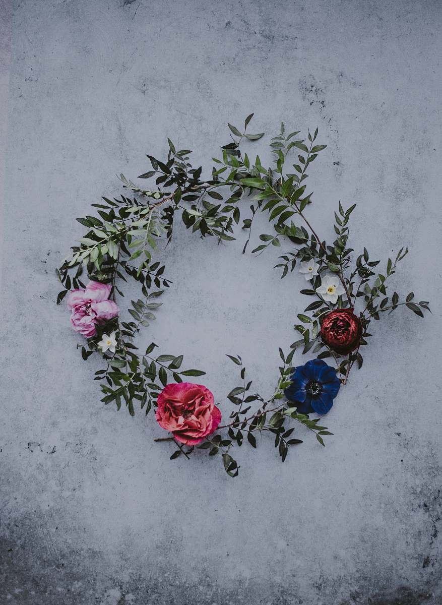 blossom red, blue, and white flower wreath on white concrete rose