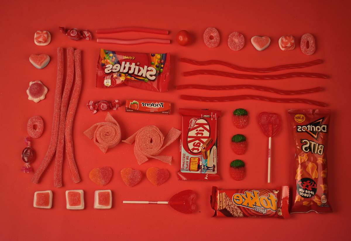 red assorted candies and chocolate pack candy