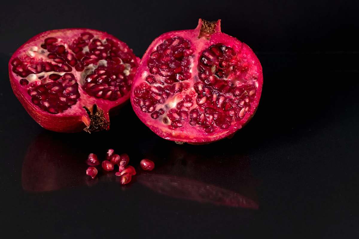 fruit focus photo of sliced red fruit pomegranate