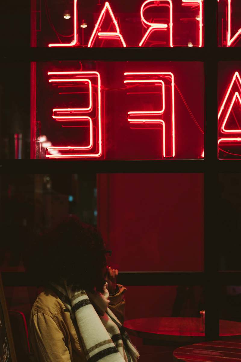 neon woman sitting near neon light signage light