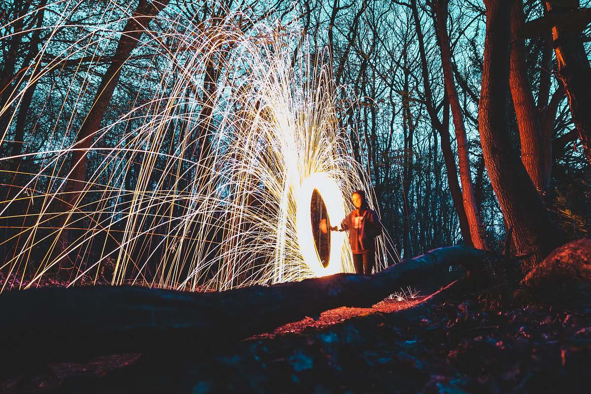 sparks woman in the middle of forest steelwool photo night