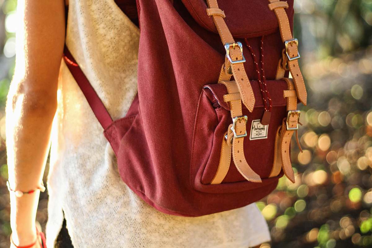 school person with red rucksack backpack