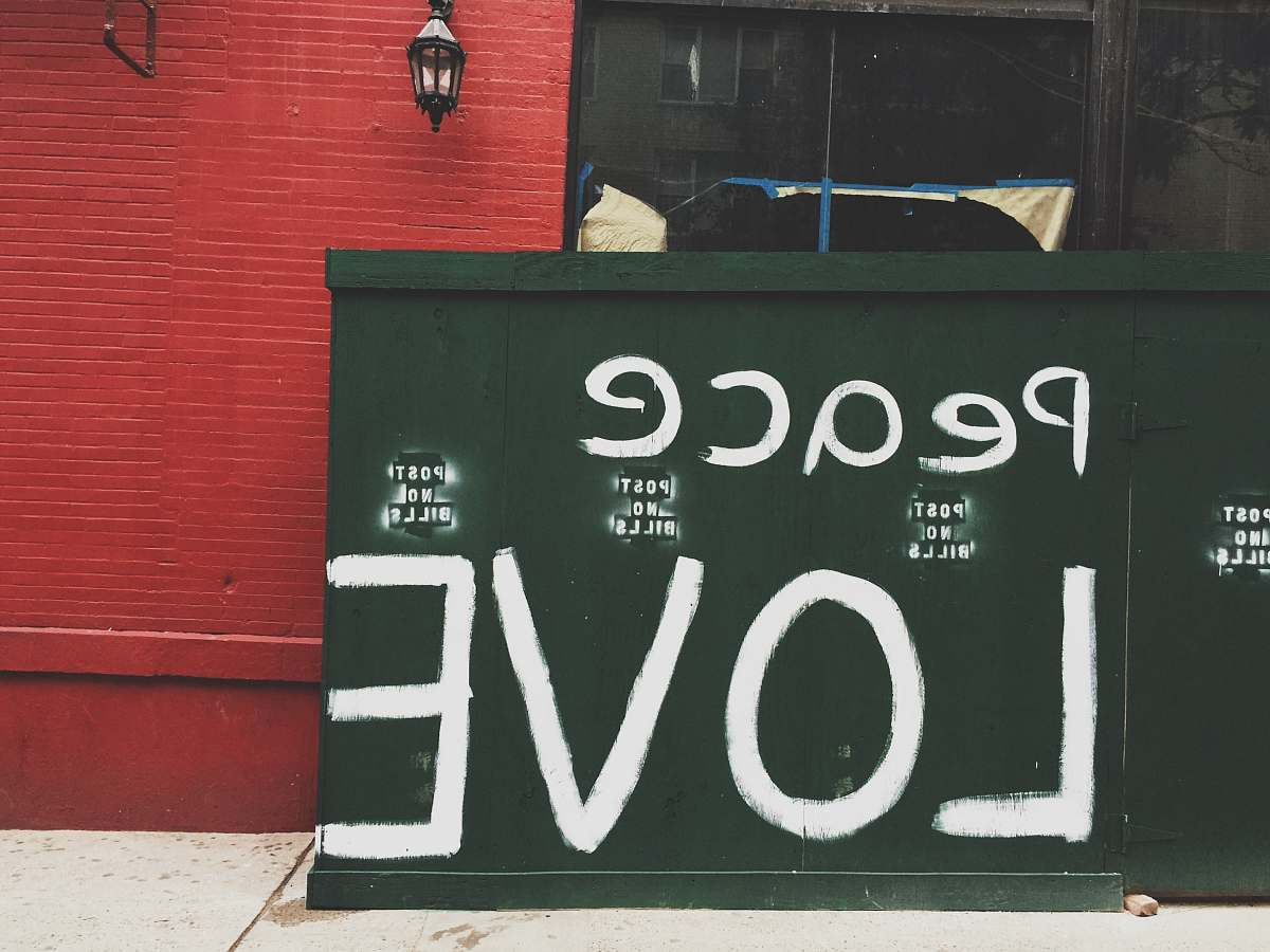 structure Peace Love painted on green wall peace