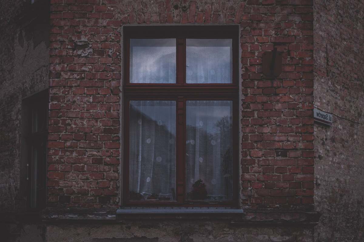 window brown framed glass windowpane brick