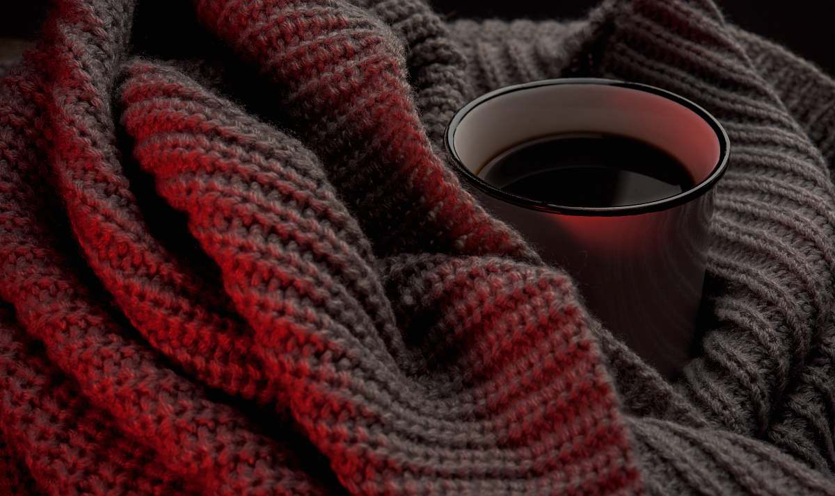 winter white cup on beige knitted cloth red
