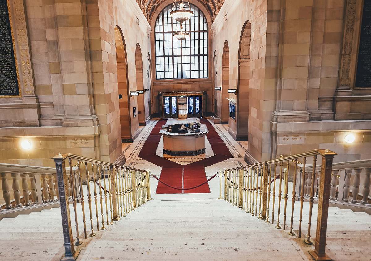 banister red carpet surrounds the reception desk aisle
