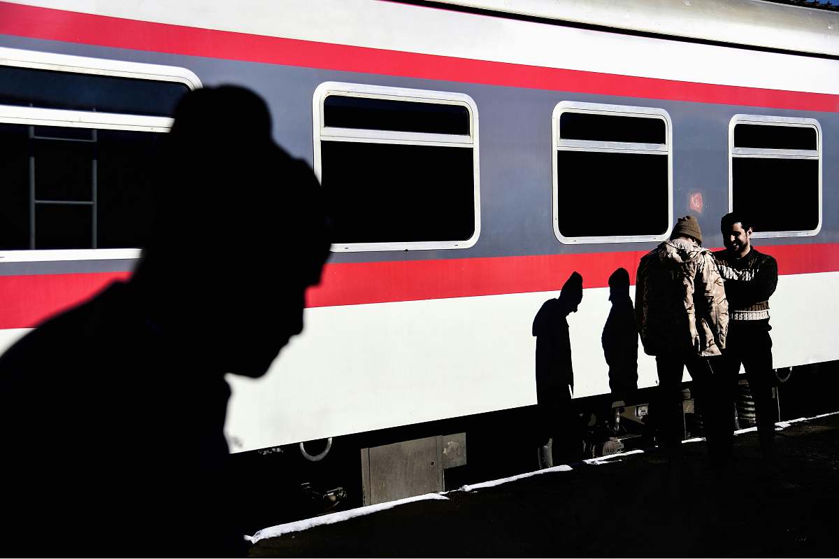 person black and white car door train station