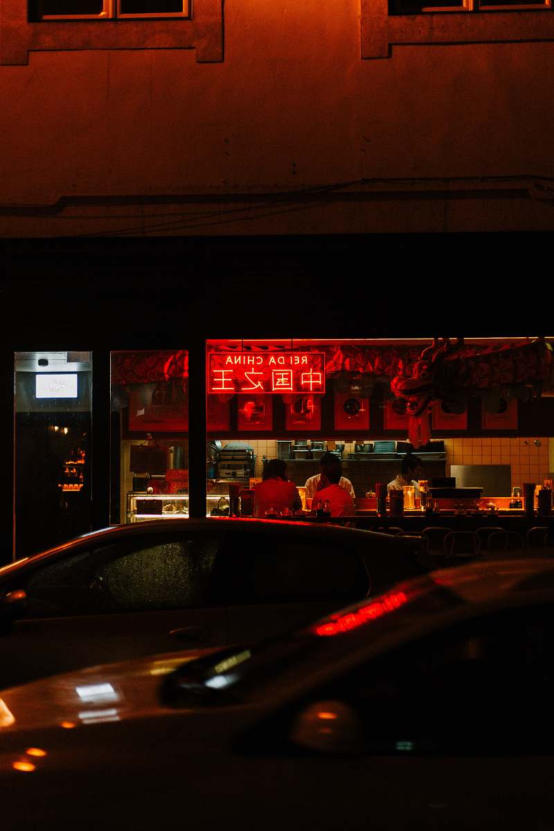 person cars parked near bar during night time portugal