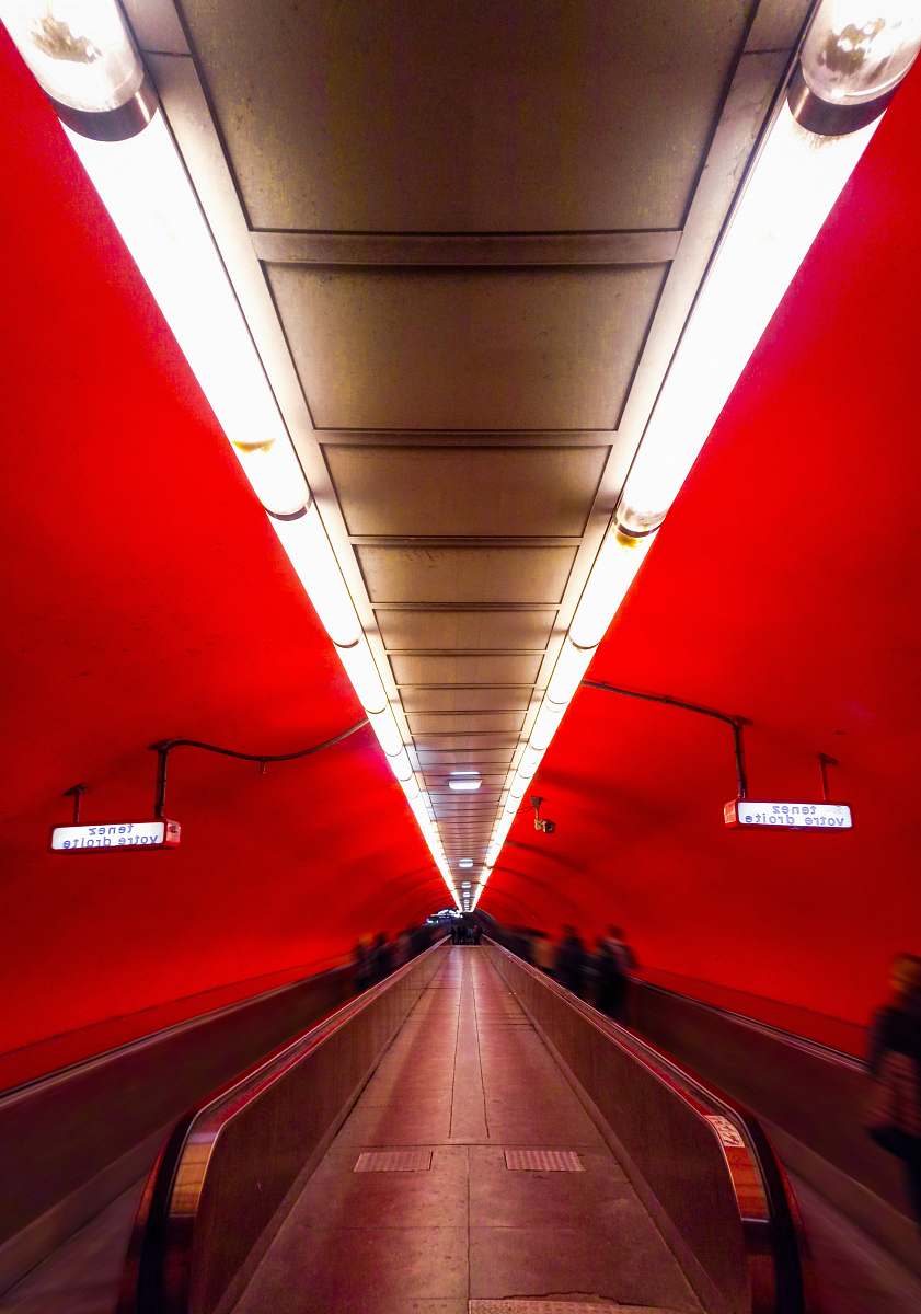 person group of people riding on the escalator tunnel