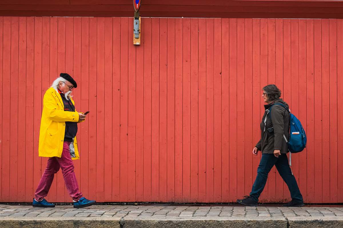 person man and woman walking on sidewalk clothing