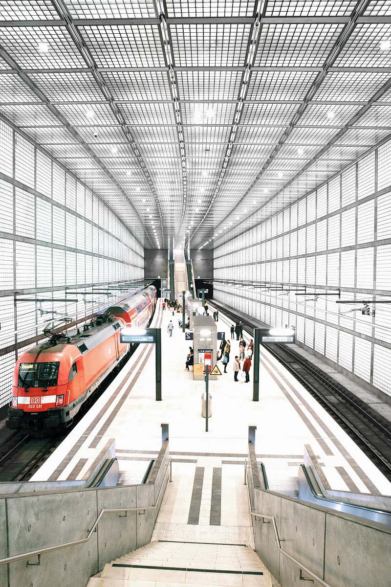 train people standing in front of red train terminal