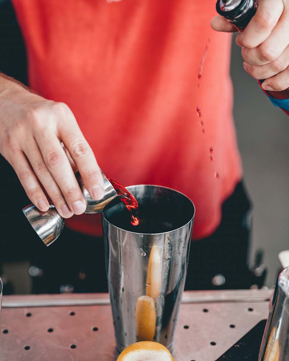 person person mixing beverage on cup finger