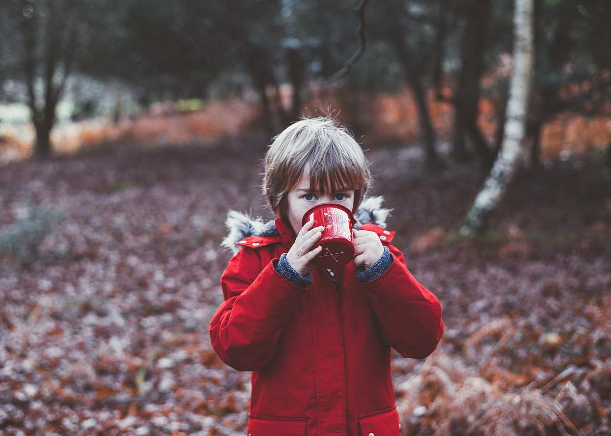 person photo of child drinking using cup outdoors during daytime people