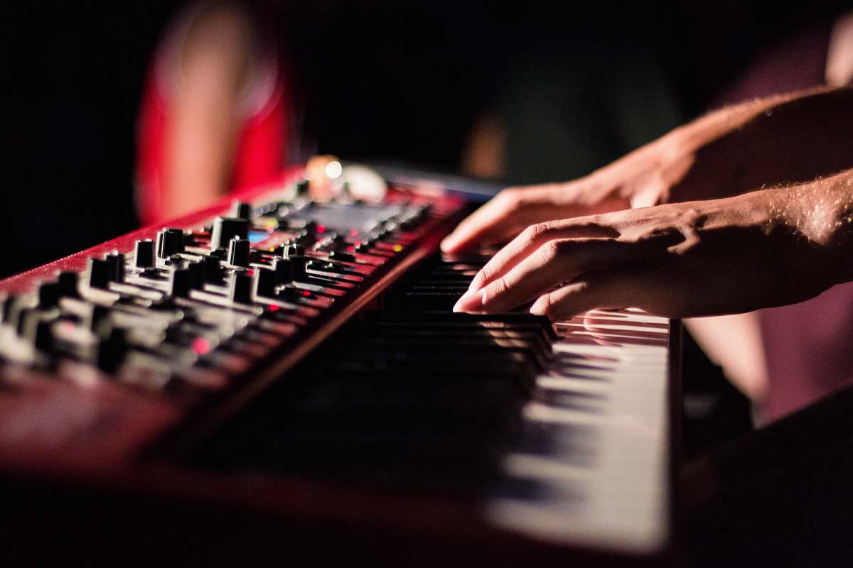 person selective focus photo of person playing electric guitar music