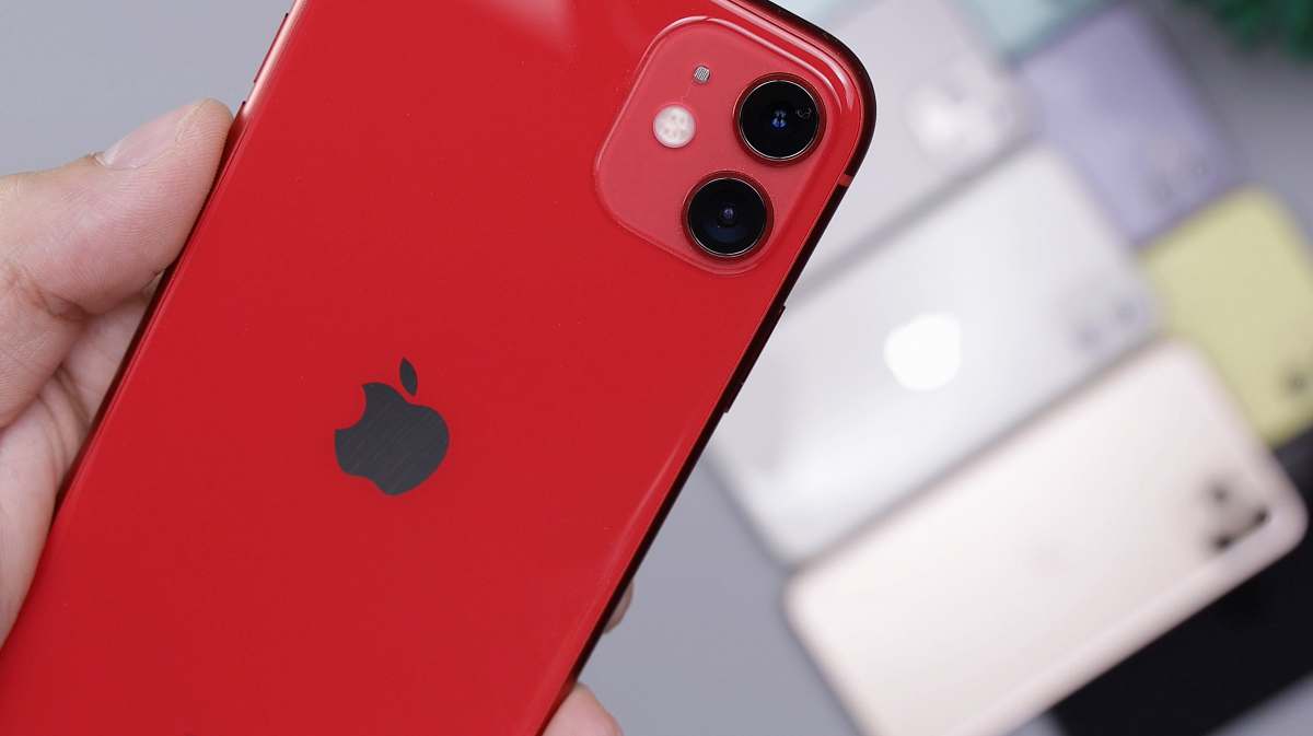 person shallow focus photo of red iPhone 11 phone