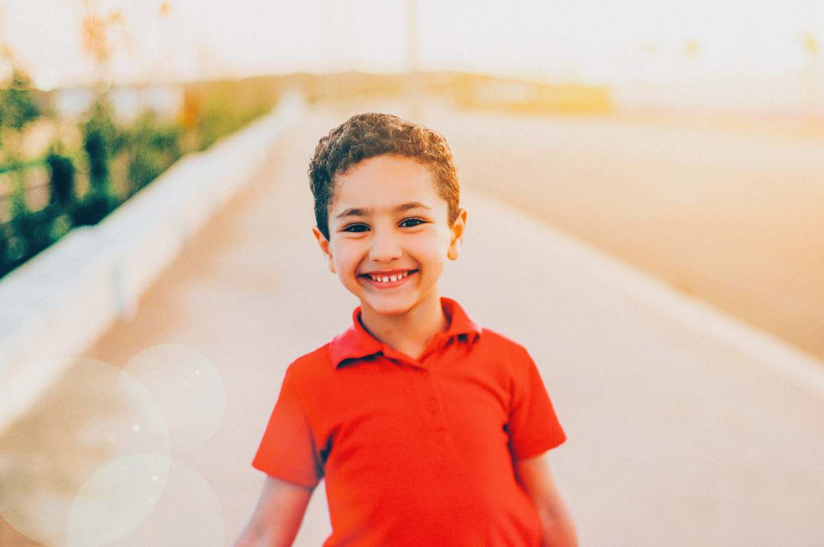 person smiling boy wearing red polo shirt people