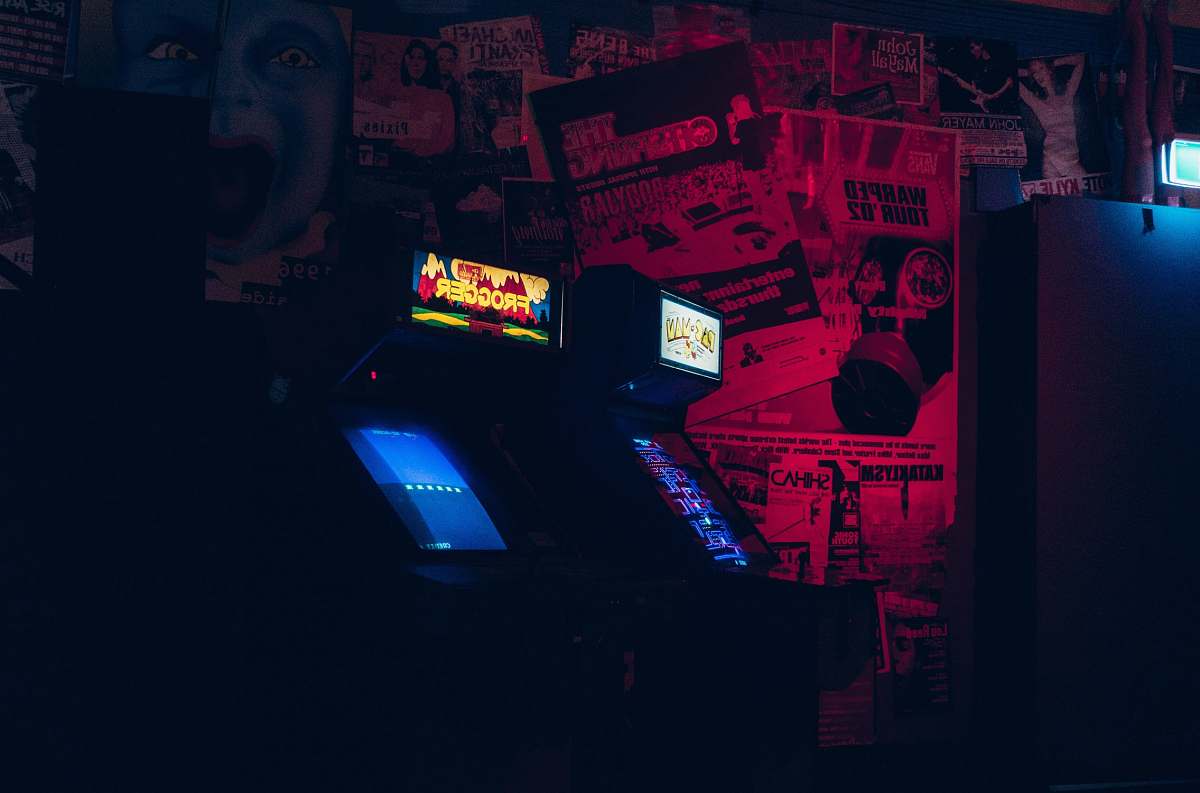 people two arcade cabinets person
