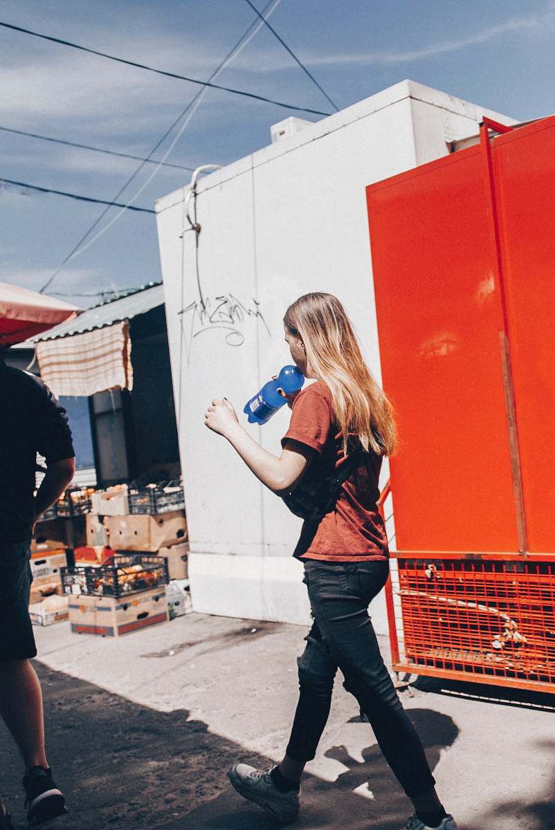 person woman holding blue plastic bottle apparel