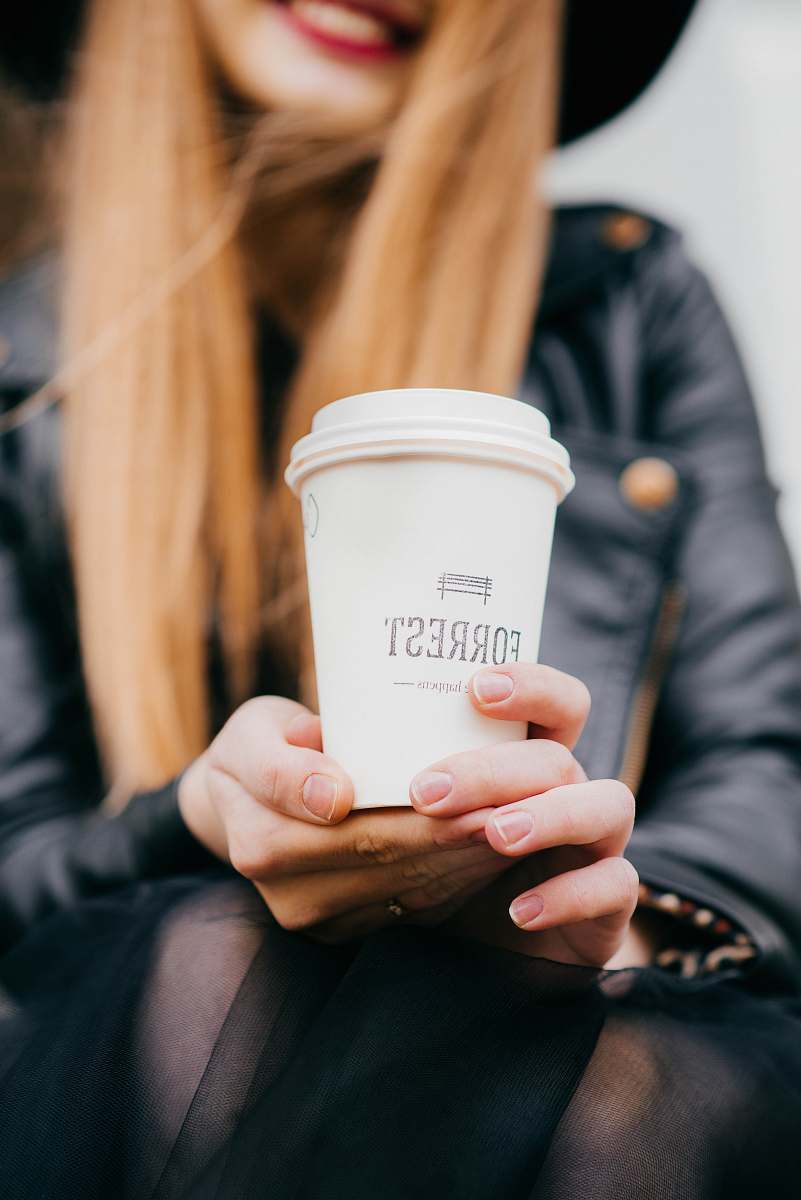 coffee woman holding white Forrest cup with lid selective focus photography cup
