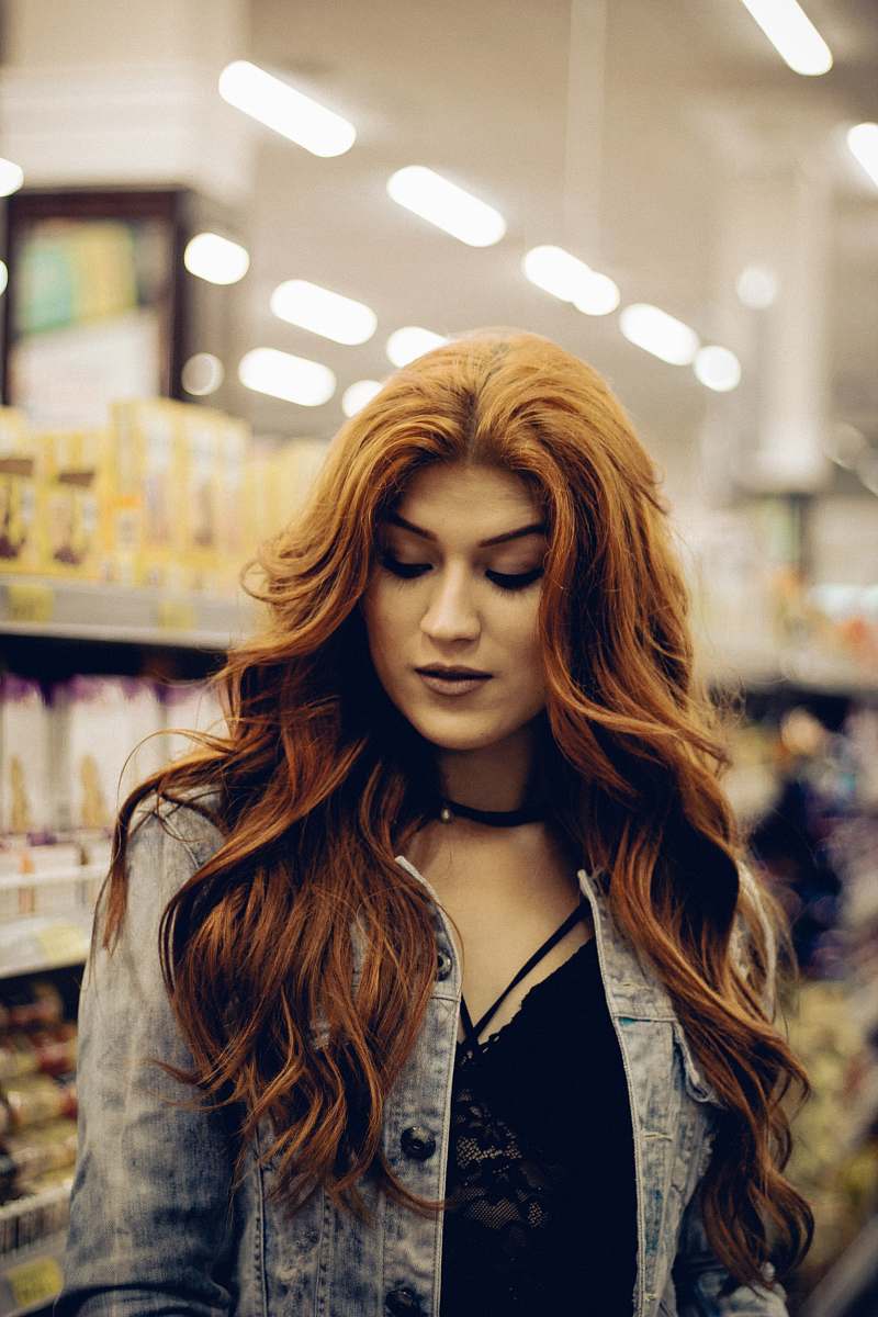 person woman looking down hair